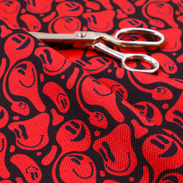 A repeating psychedelic pattern of vibrant red melting smiley faces and abstract kidney shapes set against a dark black background.