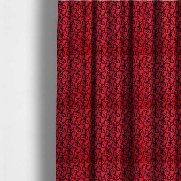 The fabric used to create these made-to-measure curtains is a repeating psychedelic pattern of vibrant red melting smiley faces and abstract kidney shapes set against a dark black background.