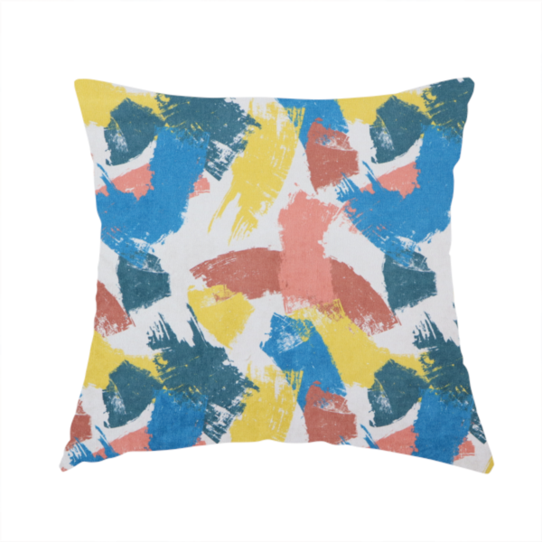 The fabric used to create this handmade cushion is a vibrant textile print featuring large, expressive paint swipes in cornflower blue, sunny yellow, terracotta red, and dark teal. The brushstrokes overlap to create a sense of movement and have a visible, dry-brush texture with distressed edges.