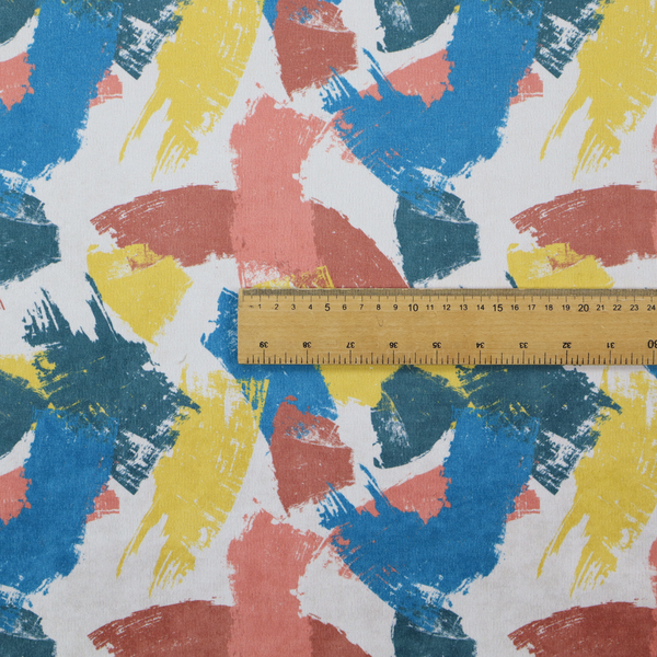 Vibrant textile print featuring large, expressive paint swipes in cornflower blue, sunny yellow, terracotta red, and dark teal. The brushstrokes overlap to create a sense of movement and have a visible, dry-brush texture with distressed edges.