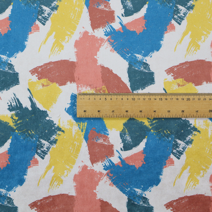 Vibrant textile print featuring large, expressive paint swipes in cornflower blue, sunny yellow, terracotta red, and dark teal. The brushstrokes overlap to create a sense of movement and have a visible, dry-brush texture with distressed edges.