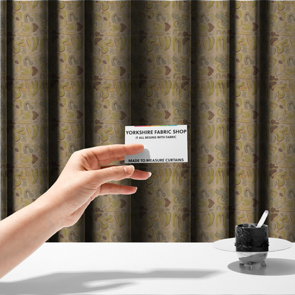 The fabric used to create these made-to-measure curtains is an abstract repeating pattern on a beige fabric background, featuring organic, amoeba-like shapes in earthy tones of olive green, muted yellow, and light brown. The design includes various fluid forms: U-shapes, elongated ovals, leaf-like outlines, and speckled pods. Some shapes are solid, while others contain interior lines, dots, or smaller concentric forms, creating a playful, mid-century modern or retro aesthetic with a soft, matte textile text