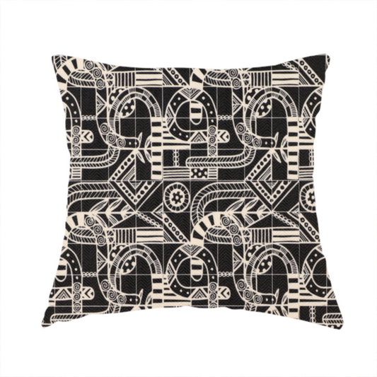The fabric used to create this handmade cushion is an intricate black and white repeating pattern featuring a grid of tribal-inspired geometric motifs. The design displays stylized, interlocking serpentine and curved forms filled with detailed line work, dots, and hatch marks. Circular gear-like symbols and triangular accents create a structured, rhythmic composition with a high-contrast, hand-drawn aesthetic on a textured fabric.