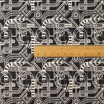 An intricate black and white repeating pattern featuring a grid of tribal-inspired geometric motifs. The design displays stylized, interlocking serpentine and curved forms filled with detailed line work, dots, and hatch marks. Circular gear-like symbols and triangular accents create a structured, rhythmic composition with a high-contrast, hand-drawn aesthetic on a textured fabric.