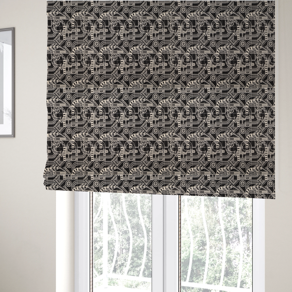 The fabric used to create these Roman blinds is an intricate black and white repeating pattern featuring a grid of tribal-inspired geometric motifs. The design displays stylized, interlocking serpentine and curved forms filled with detailed line work, dots, and hatch marks. Circular gear-like symbols and triangular accents create a structured, rhythmic composition with a high-contrast, hand-drawn aesthetic on a textured fabric.