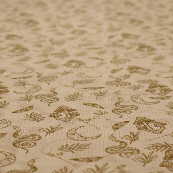 A light beige fabric featuring a repetitive boho-mystical pattern. The design is printed in a muted olive-brown ink and includes the following hand-drawn elements scattered across the material.