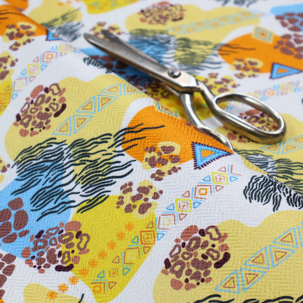 A vibrant, safari-themed repeating pattern on a white textured fabric, blending abstract shapes with traditional animal and tribal motifs.