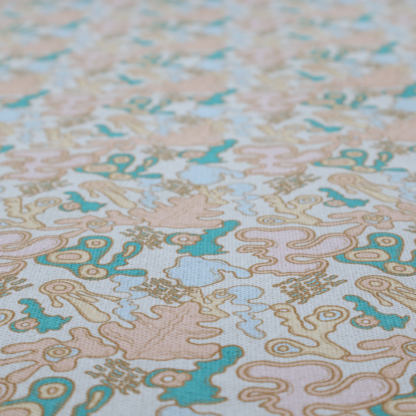 This fabric is a light blue fabric featuring a whimsical, abstract botanical pattern. The design is composed of organic, flowing shapes and illustrations in a pastel and jewel-tone palette.