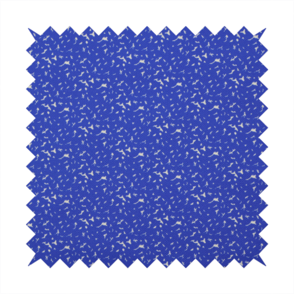 A bright cobalt blue fabric with a dense, non-directional "speckle" or "splatter" pattern.