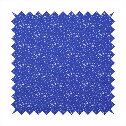 A bright cobalt blue fabric with a dense, non-directional "speckle" or "splatter" pattern.