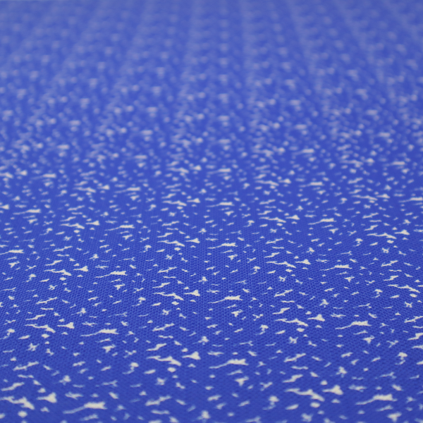 A bright cobalt blue fabric with a dense, non-directional "speckle" or "splatter" pattern.