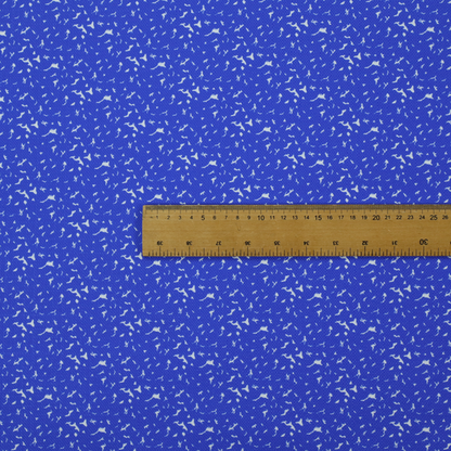 A bright cobalt blue fabric with a dense, non-directional "speckle" or "splatter" pattern.
