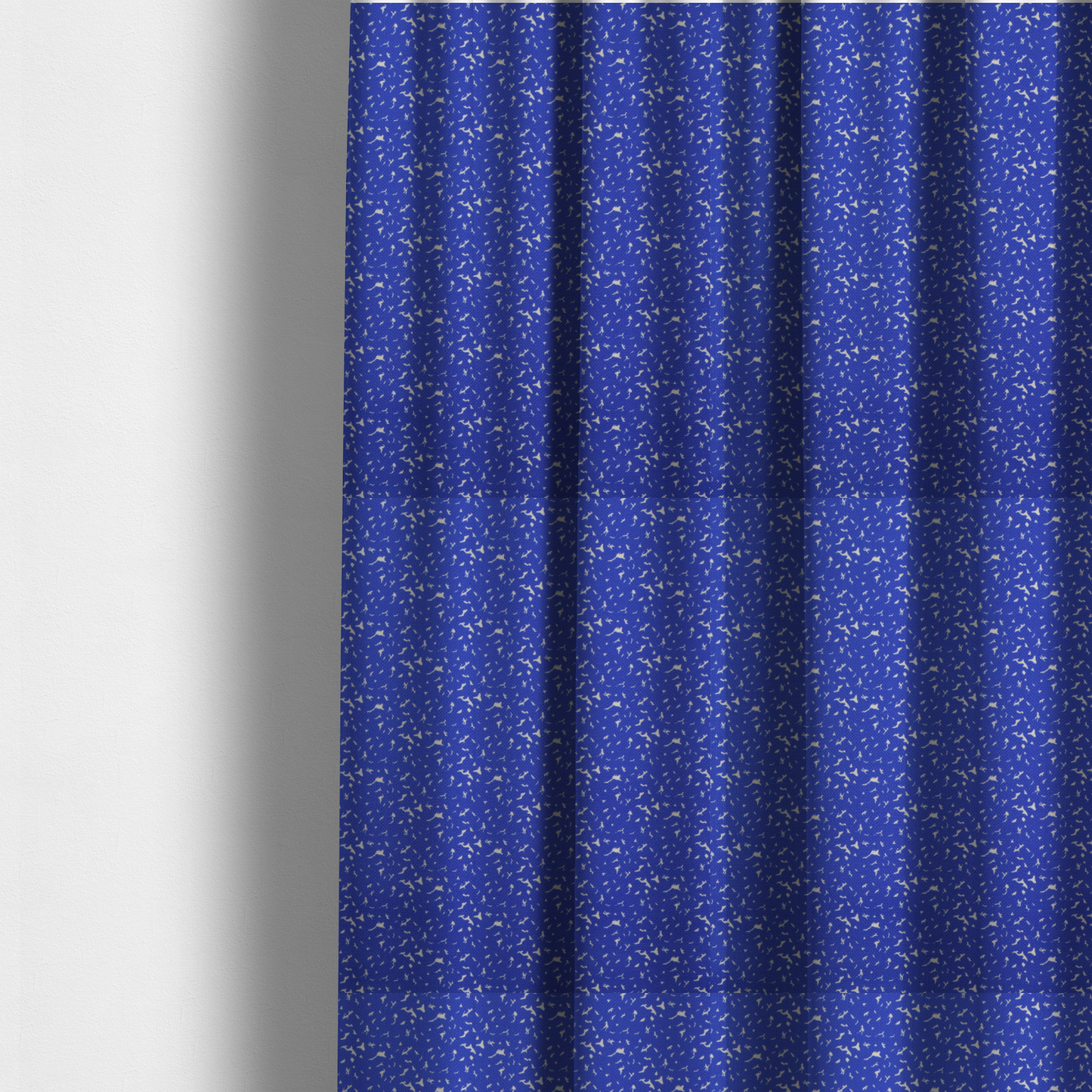 The fabric used to create these made-to-measure curtains is a bright cobalt blue fabric with a dense, non-directional "speckle" or "splatter" pattern.