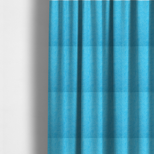 The fabric used to create these made-to-measure curtains is a vibrant cyan-coloured fabric featuring a subtle, tonal geometric pattern.