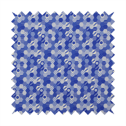 A detailed geometric fabric featuring a dense honeycomb or hexagonal patchwork pattern in blue and white.