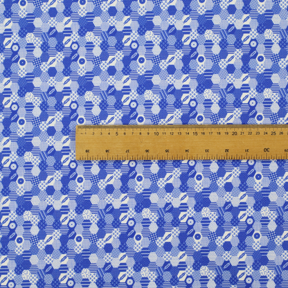 A detailed geometric fabric featuring a dense honeycomb or hexagonal patchwork pattern in blue and white.