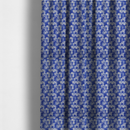 The fabric used to create these made-to-measure curtains is a detailed geometric fabric featuring a dense honeycomb or hexagonal patchwork pattern in blue and white.