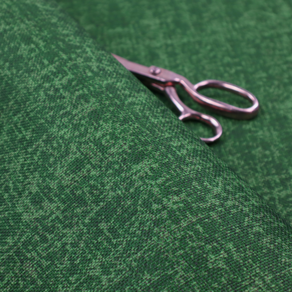This fabric has a low contrast between the base colour and the print, the design reveals more detail upon closer inspection, offering a rich and understated elegance in different green tones.