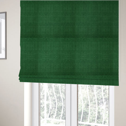 The fabric used to create these Roman blinds has a low contrast between the base colour and the print, the design reveals more detail upon closer inspection, offering a rich and understated elegance in different green tones.