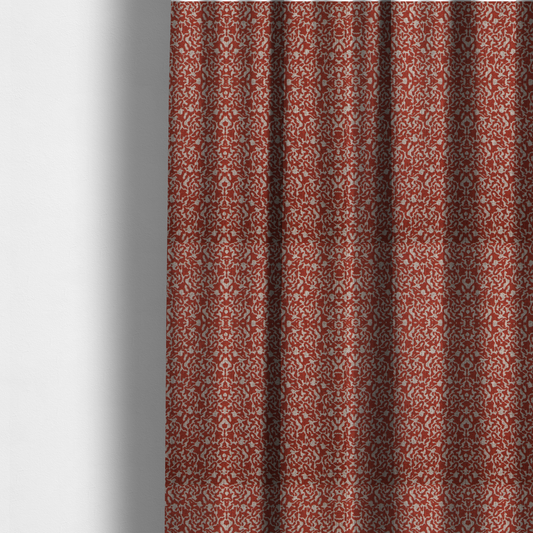 The fabric used to create these made-to-measure curtains is a decorative textile featuring a symmetrical, kaleidoscopic pattern in red and beige. The intricate, interlocking organic shapes create a dense, filigree-like design with a slightly weathered or distressed look. The fabric has a visible, fine-textured weave that gives the pattern a soft, matte appearance.