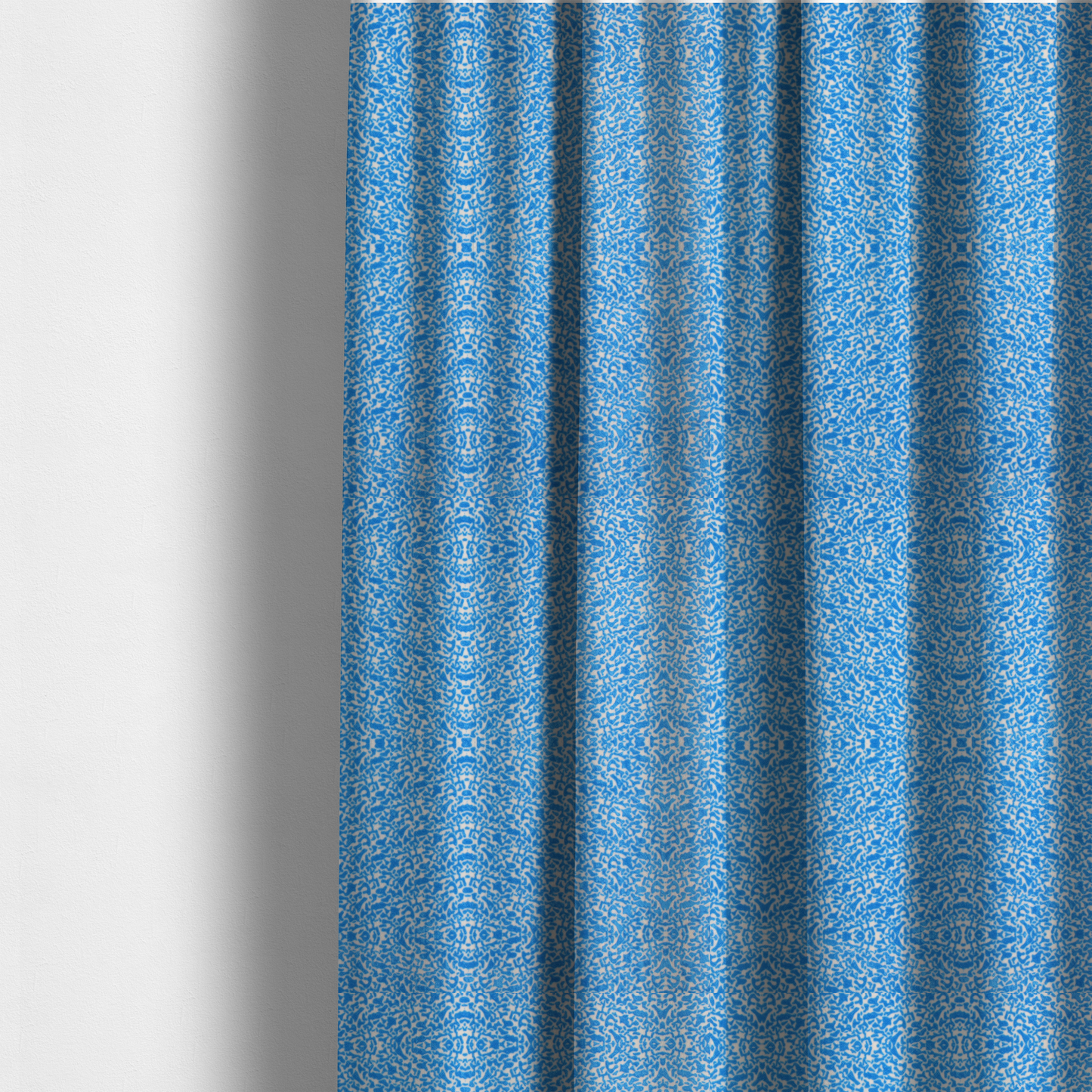 The fabric used to create these made-to-measure curtains is a symmetrical, kaleidoscopic textile pattern in bright azure blue and white. The design features intricate, interlocking organic shapes mirrored vertically and horizontally to create a dense, mosaic-like filigree across the fabric.