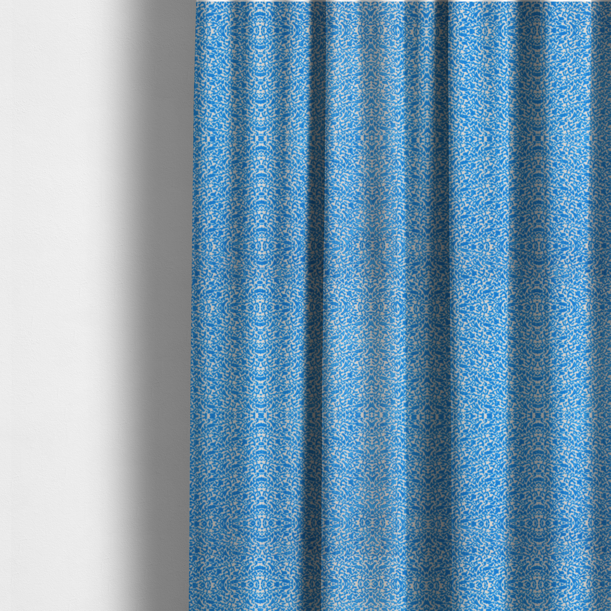 The fabric used to create these made-to-measure curtains is a symmetrical, kaleidoscopic textile pattern in bright azure blue and white. The design features intricate, interlocking organic shapes mirrored vertically and horizontally to create a dense, mosaic-like filigree across the fabric.