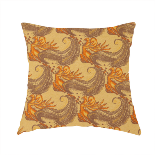 The fabric used to create this handmade cushion is a repeating pattern of large, curved scroll shapes that look like stylized seashells or feathers. These shapes feature a grey crosshatch 'grid' texture and are decorated with bright orange and gold accents. The entire design is set against a solid, warm tan background.