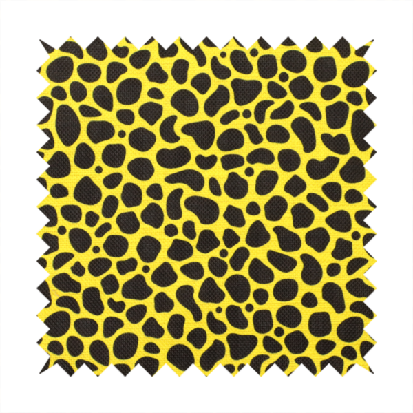A bold cheetah-style animal print featuring irregular, black organic spots scattered across a bright canary yellow background.