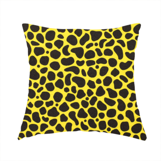 The fabric used to create this handmade cushion is a bold cheetah-style animal print featuring irregular, black organic spots scattered across a bright canary yellow background.