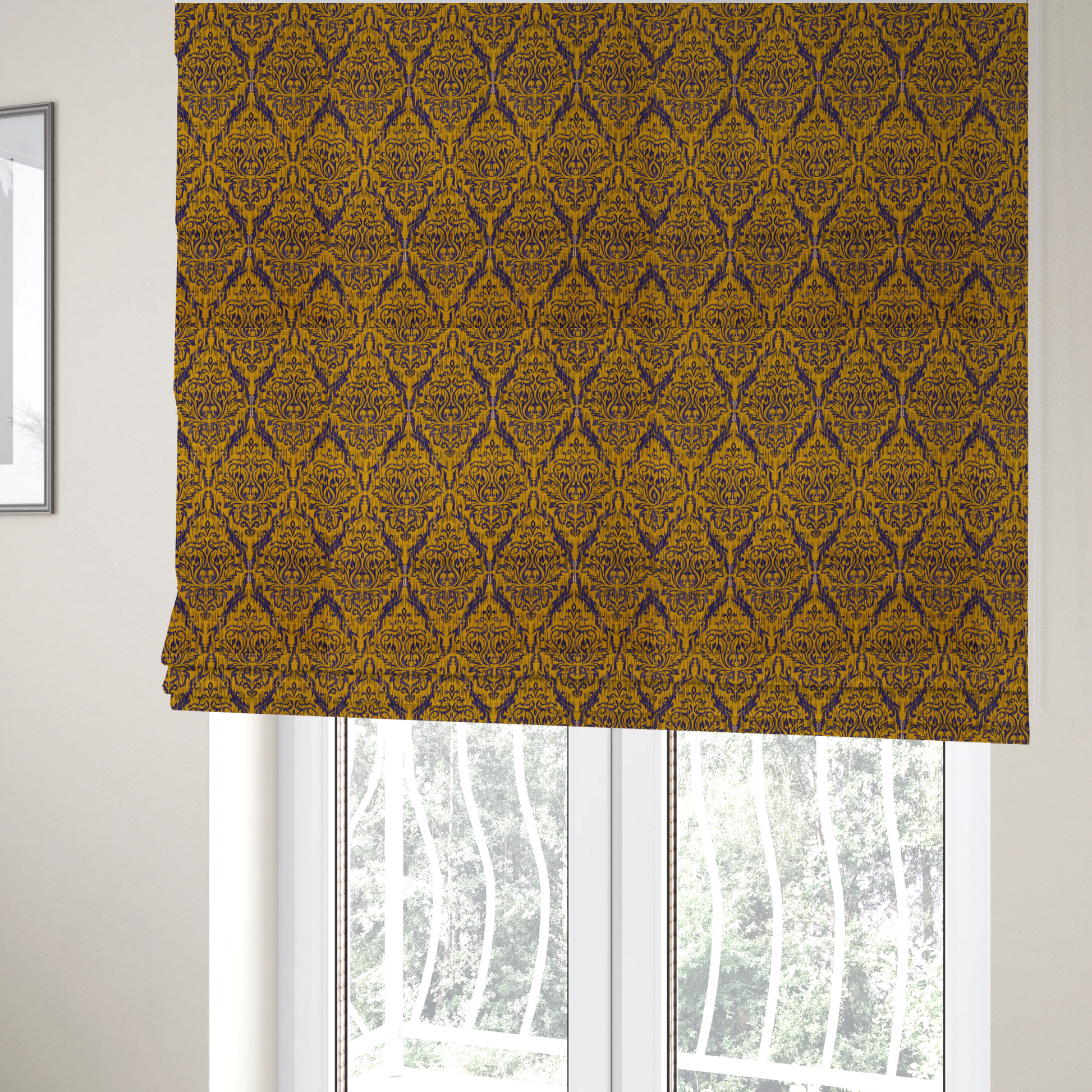 The fabric used to create these Roman blinds features a royal blue damask pattern layered over a deep mustard gold background. The design has an ikat-inspired finish, with vertical, feathered edges that give the ornate fleur-de-lis motifs a slightly blurred, textured appearance.