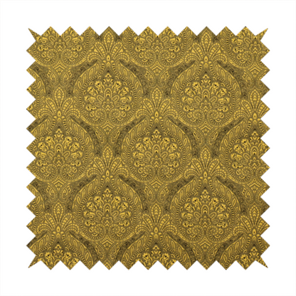 An intricate textile pattern featuring elaborate paisley-style medallions in black line work over an antique gold background. The design is highly detailed with swirling filigree, floral elements, and a repeating teardrop composition that creates a classic, traditional aesthetic.