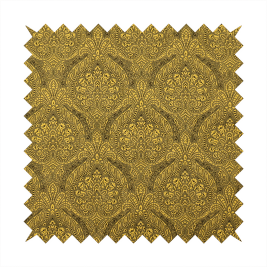 An intricate textile pattern featuring elaborate paisley-style medallions in black line work over an antique gold background. The design is highly detailed with swirling filigree, floral elements, and a repeating teardrop composition that creates a classic, traditional aesthetic.