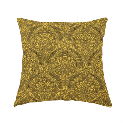 The fabric used to create these handmade cushions is an intricate textile pattern featuring elaborate paisley-style medallions in black line work over an antique gold background. The design is highly detailed with swirling filigree, floral elements, and a repeating teardrop composition that creates a classic, traditional aesthetic.