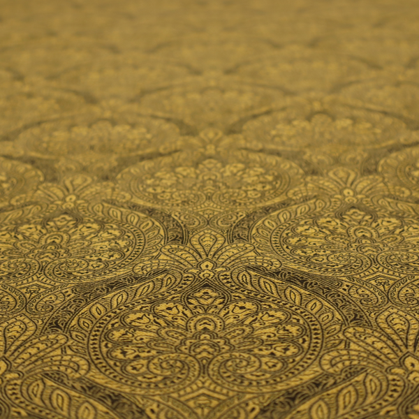 An intricate textile pattern featuring elaborate paisley-style medallions in black line work over an antique gold background. The design is highly detailed with swirling filigree, floral elements, and a repeating teardrop composition that creates a classic, traditional aesthetic.