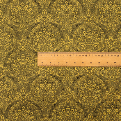 An intricate textile pattern featuring elaborate paisley-style medallions in black line work over an antique gold background. The design is highly detailed with swirling filigree, floral elements, and a repeating teardrop composition that creates a classic, traditional aesthetic.