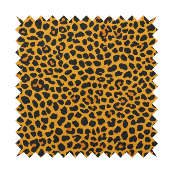 A high-contrast animal print fabric featuring a dense leopard-inspired pattern. The design consists of irregular black spots and open rosettes with warm orange-brown centres, set against a vibrant mustard-yellow background. The print is small-scale and tightly packed, with a visible fine-grained textile texture