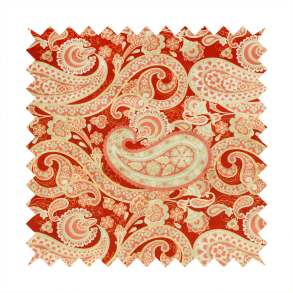A vibrant, warm-toned textile featuring large-scale paisley teardrop motifs in shades of cream, pale mint, and soft orange against a bold red background. The intricate patterns within the paisley shapes include delicate floral borders and internal mandalas, surrounded by smaller scattered flower accents for a rich, traditional Indian-inspired aesthetic.