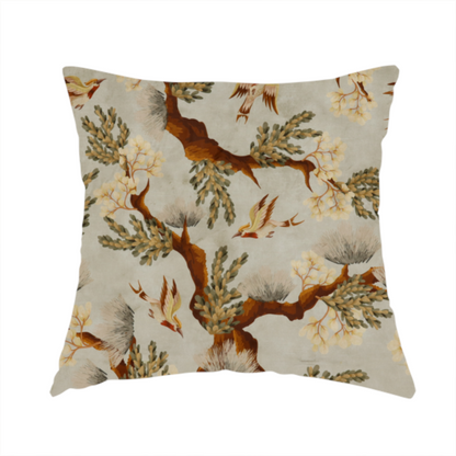 The fabric used to create this handmade cushions is a sophisticated textile featuring a Chinoiserie-style pattern with stylized birds in flight among winding, dark brown tree branches. The branches are adorned with clusters of pale cream blossoms and soft, pine-like needles. The entire design is set against a muted beige background creating a serene and classical aesthetic.