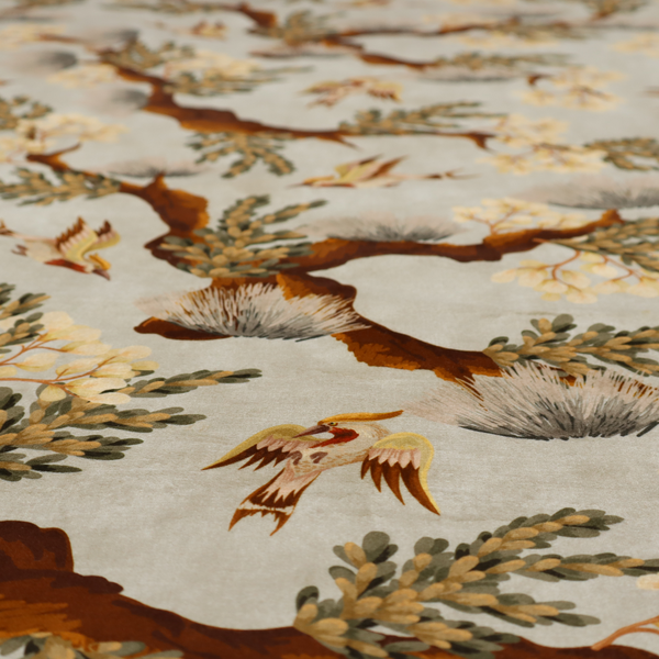 A sophisticated textile featuring a Chinoiserie-style pattern with stylized birds in flight among winding, dark brown tree branches. The branches are adorned with clusters of pale cream blossoms and soft, pine-like needles. The entire design is set against a muted beige background creating a serene and classical aesthetic.