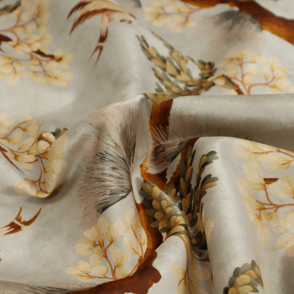 A sophisticated textile featuring a Chinoiserie-style pattern with stylized birds in flight among winding, dark brown tree branches. The branches are adorned with clusters of pale cream blossoms and soft, pine-like needles. The entire design is set against a muted beige background creating a serene and classical aesthetic.