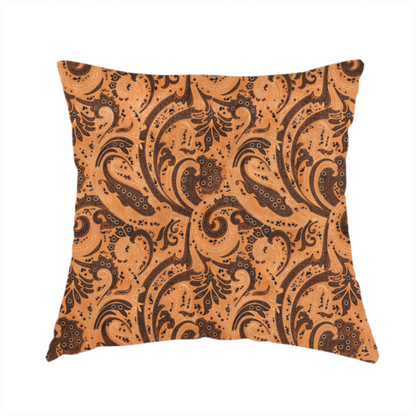 The fabric used to create this handmade cushion is a complex textile design featuring an all-over paisley and scroll pattern in solid black over a warm copper-orange background. The motifs are highly stylized with a mixture of dotted textures, fine line work, and bold curves that resemble ocean waves or flowing vines. The high-contrast colour palette gives the fabric a sophisticated, bohemian-luxe appearance.