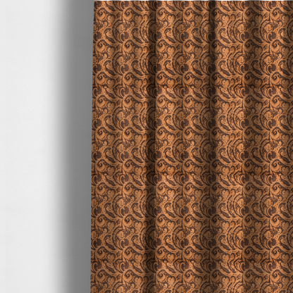 The fabric used to create these made-to-measure curtains is a complex textile design featuring an all-over paisley and scroll pattern in solid black over a warm copper-orange background. The motifs are highly stylized with a mixture of dotted textures, fine line work, and bold curves that resemble ocean waves or flowing vines. The high-contrast colour palette gives the fabric a sophisticated, bohemian-luxe appearance.