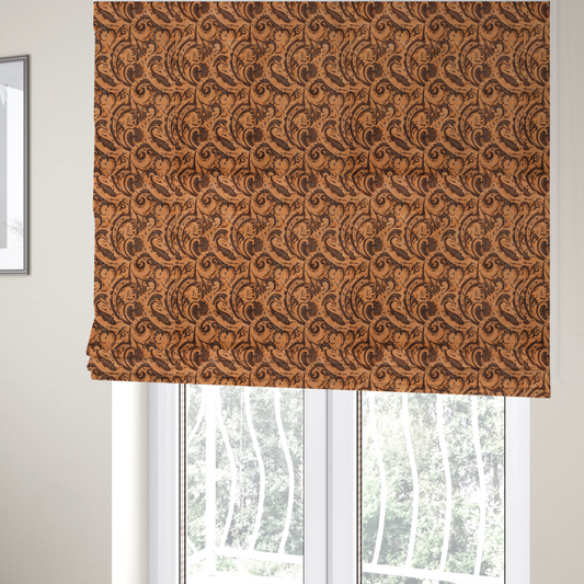 The fabric used to create these Roman blinds is a complex textile design featuring an all-over paisley and scroll pattern in solid black over a warm copper-orange background. The motifs are highly stylized with a mixture of dotted textures, fine line work, and bold curves that resemble ocean waves or flowing vines. The high-contrast colour palette gives the fabric a sophisticated, bohemian-luxe appearance.