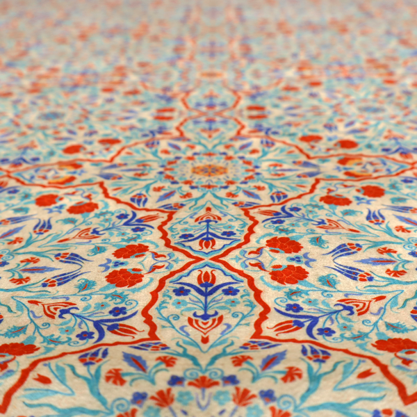 A decorative fabric with an Ottoman-style floral print. The design consists of repeating cobalt blue and turquoise tulips and deep red carnations intertwined with long, curving green leaves. The pattern mimics 16th-century Mediterranean ceramic tile art.