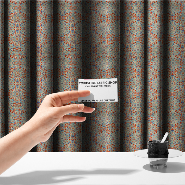 The fabric used to create these made-to-measure curtains is a decorative fabric with an Ottoman-style floral print. The design consists of repeating cobalt blue and turquoise tulips and deep red carnations intertwined with long, curving green leaves. The pattern mimics 16th-century Mediterranean ceramic tile art.