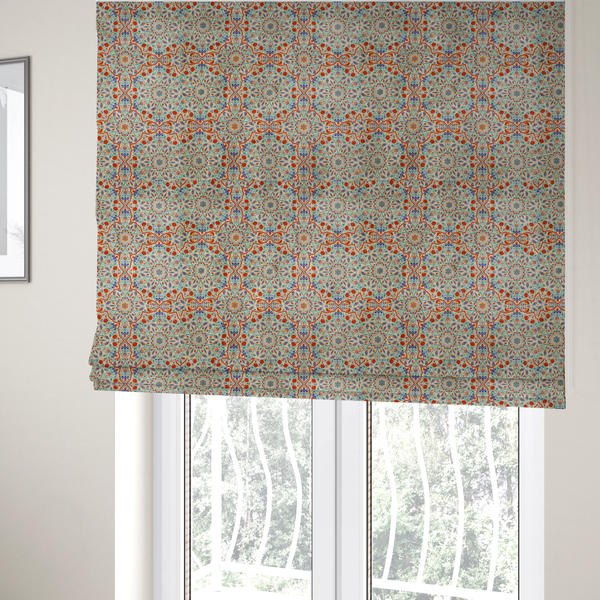 The fabric used to create these Roman blinds is a decorative fabric with an Ottoman-style floral print. The design consists of repeating cobalt blue and turquoise tulips and deep red carnations intertwined with long, curving green leaves. The pattern mimics 16th-century Mediterranean ceramic tile art.