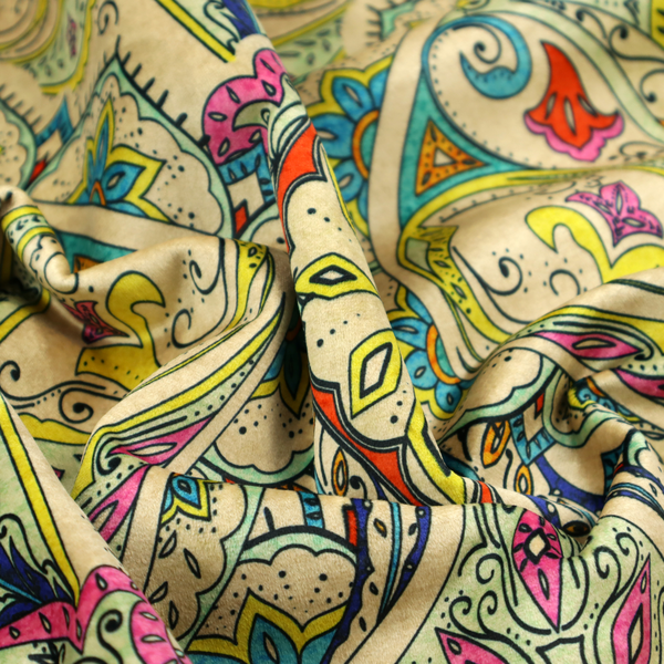 Vibrant bohemian paisley fabric with an intricate damask-style pattern featuring teal, yellow, pink, and orange motifs accented by bold black outlines on a warm cream background.