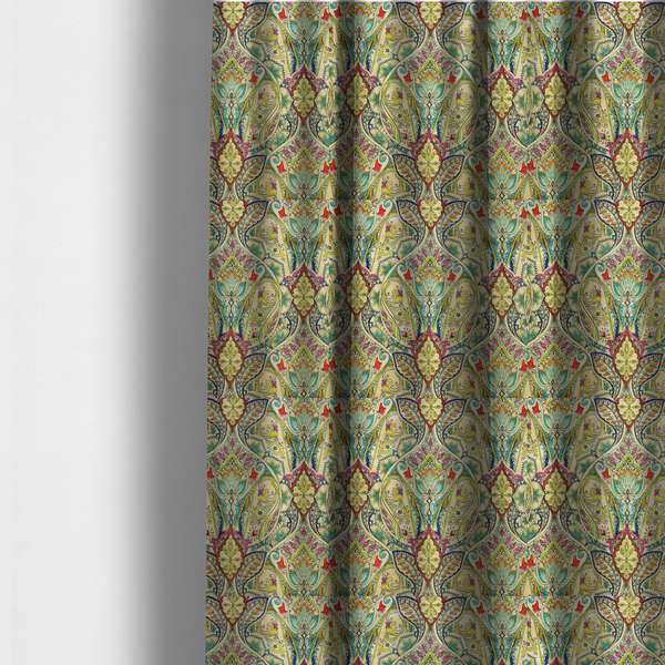 The fabric used to create these made-to-measure curtains is a vibrant bohemian paisley fabric with an intricate damask-style pattern featuring teal, yellow, pink, and orange motifs accented by bold black outlines on a warm cream background