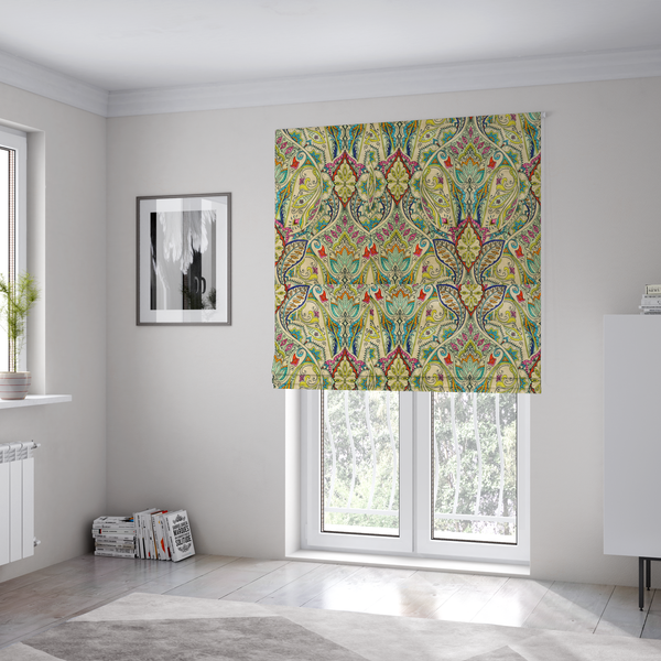 The fabric used to create these Roman blinds is a vibrant bohemian paisley fabric with an intricate damask-style pattern featuring teal, yellow, pink, and orange motifs accented by bold black outlines on a warm cream background