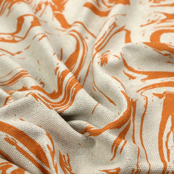 Abstract marbled fabric featuring fluid, organic swirls in a warm burnt orange colour over a textured cream-colored background.